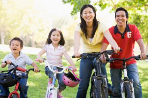 Family on bikes outdoors smiling
